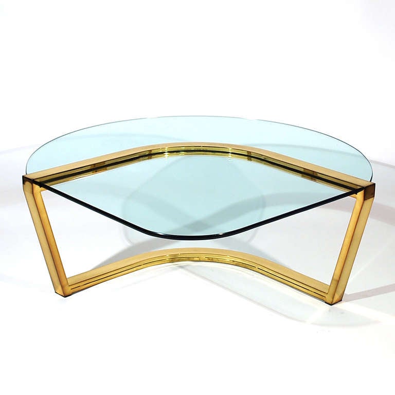 Milo Baughman for DIA cocktail/coffee table. Unique baseball field form. The triangular fan form glass is supported by the curving brass base.

Please call Stacey for a detailed condition report, shipping inquiries or with any general questions.
