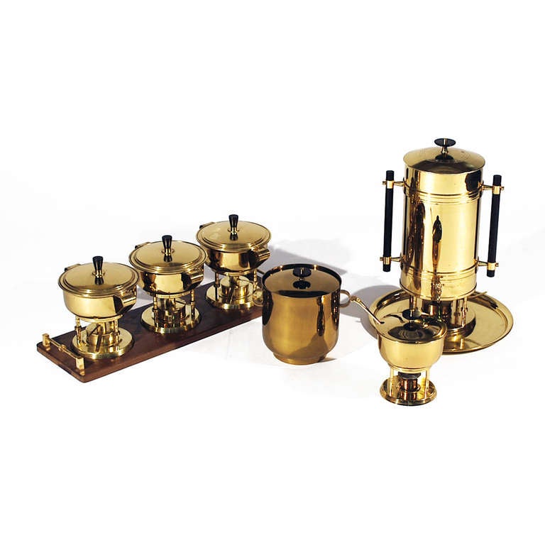 Brass Serving Set by Tommi Parzinger for Dorlyn Silversmiths, circa 1950's. The Set consists of an extra large coffee urn, an ice bucket, an individual chafing dish with matching fork and a wonderful four piece chafing dish set where 3 chafing