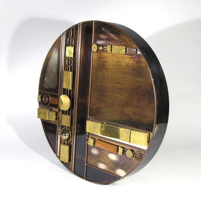 Spectacular rare Curtis Jere wall sculpture. Colossal thick disc form comprising a myriad of metals, techniques, and finishes. Geometric forms of welded copper, brass, and steel applied over diverse flat surfaces, sectioned off by copper rods.