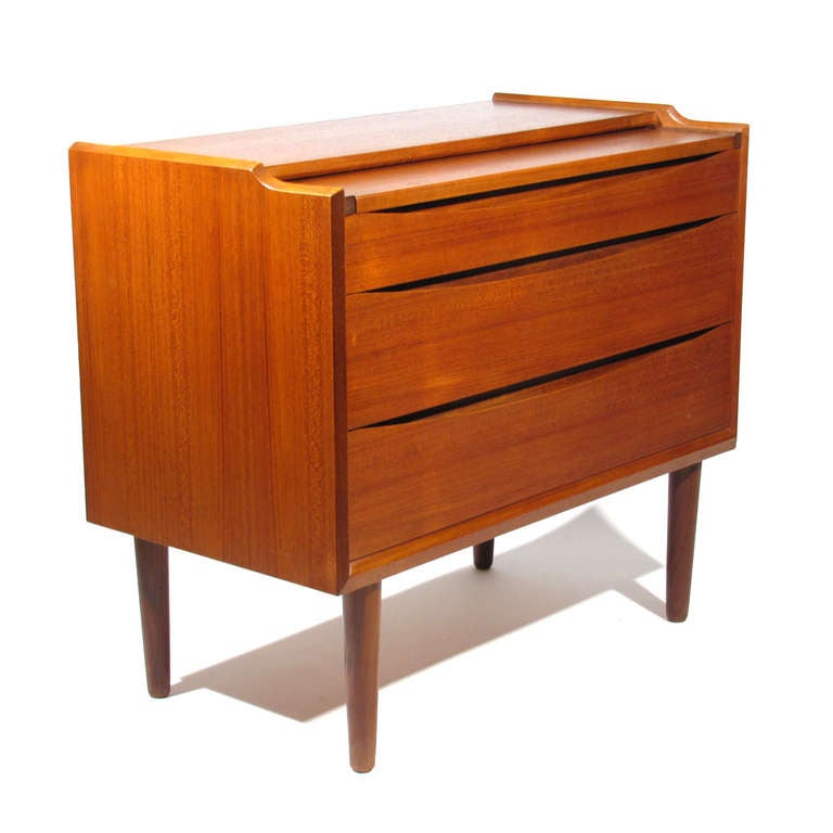 Arne Vodder for Sibast rare Danish teak vanity desk with flip top mirror. Original chrome cone mirror hardware and lavender cream interior. Top writing surface glides out with ease for easy transformation from vanity to desk with two lower drawers.
