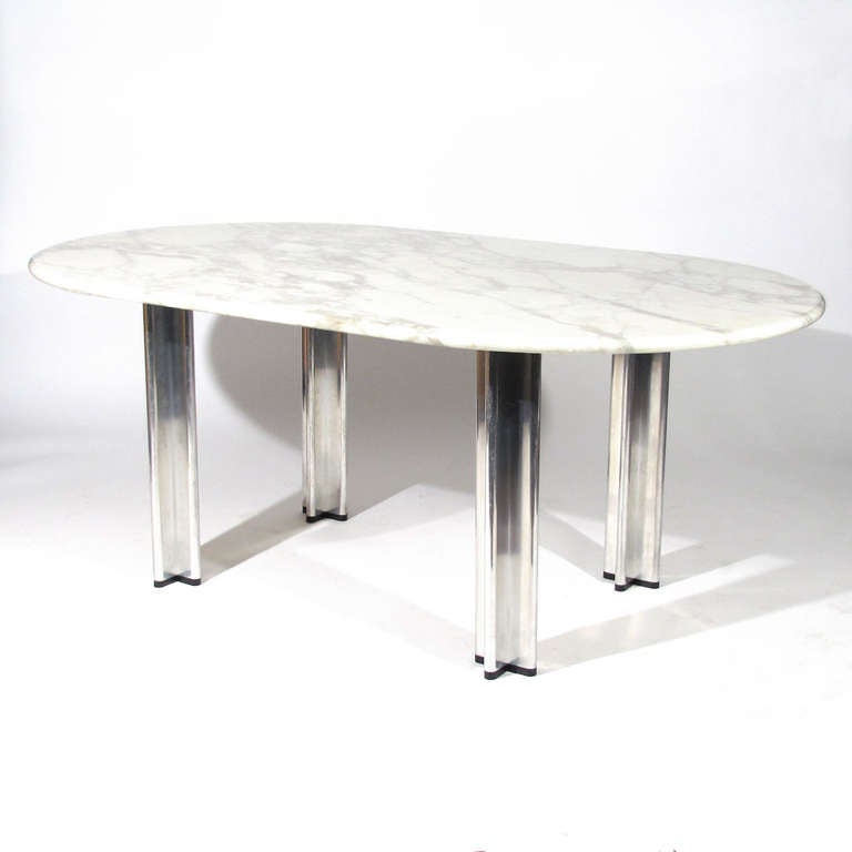 Sleek Italian dining table designed by Pascal Mourgue for Knoll. Thick oval marble top rests on x form chrome legs with black feet. 

Excellent condition. Please call Eddy at 410.299.9147 for detailed condition report, shipping inquiries, or with