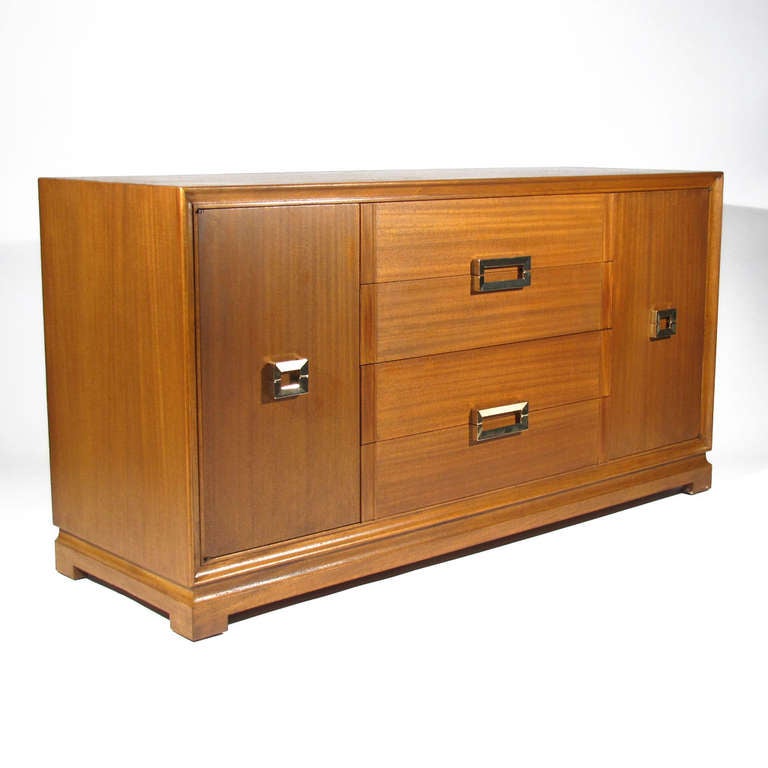 Red Lion sideboard or dresser in walnut with polished brass pulls. Two doors flanking four drawers reveal shelved compartments. 

Impeccably refinished, brass polished and lacquered. Please call Stacey for a detailed condition report, shipping