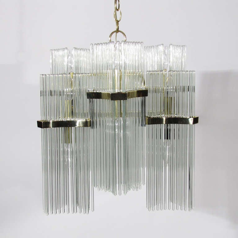 Gaetano Sciolari Italian chandelier comprising twelve lights within six chambers, each pair bordered by thirty four glass rods for a total of two hundred four. Long chain and ceiling plate for flush mount.

Excellent condition.