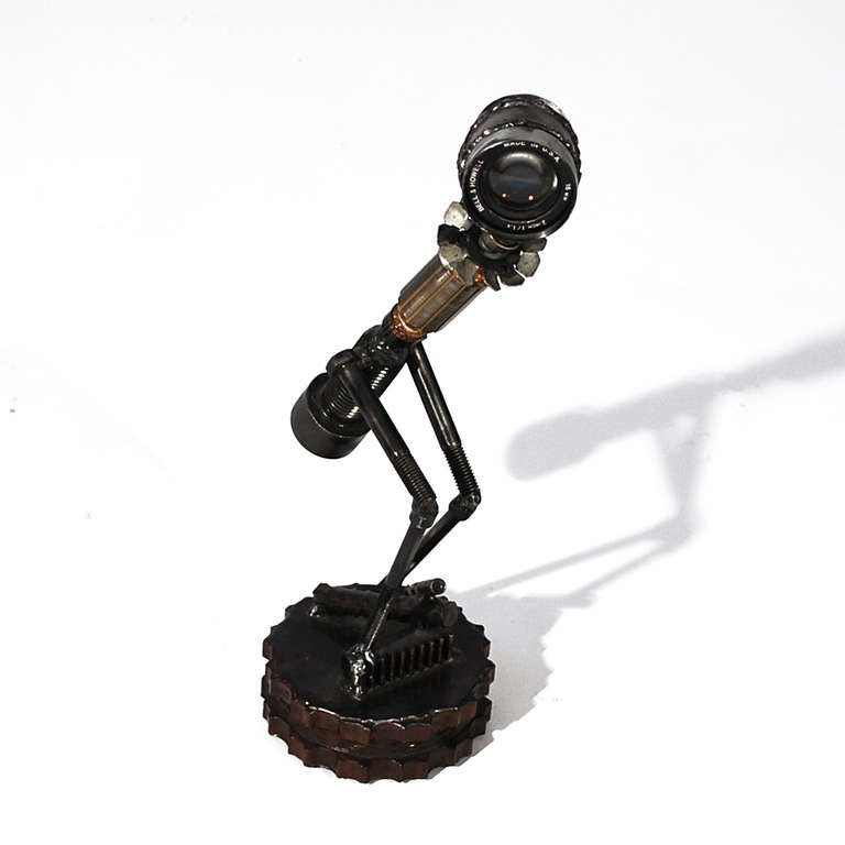 One of a kind found art Steampunk sculpture made from old car, camera, and industrial parts. Striking and whimsical at the same time.
