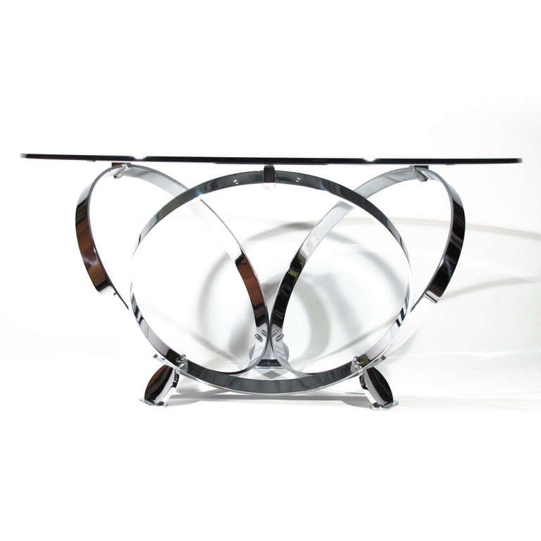 Brilliant Ronald Schmitt coffee table with unusually heavy flat bar chrome. Three locking rings joined by three disc feet, all connected with chrome hardware. Chrome thickness and quality is superior to what we generally come across in 20th Century