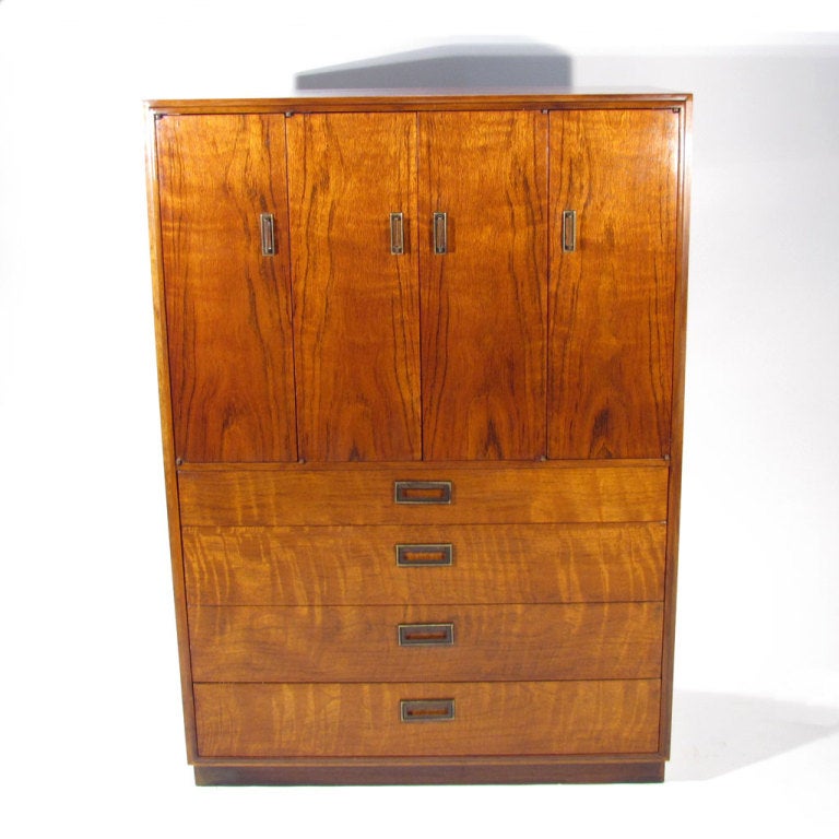Tall chest with unusually dramatic walnut and beautiful deep color. Two front folding doors reveal six positionable shelves above four dresser drawers. 

Overall excellent restored condition. Pristine interior. All drawers and doors operate with
