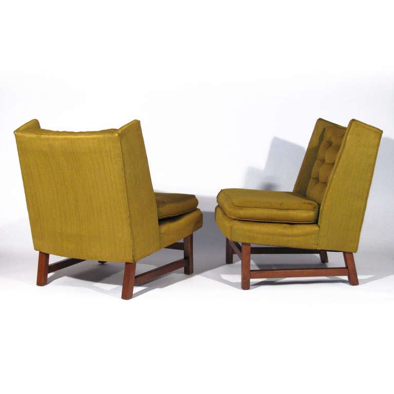 Elegant Pair of 1950's Mid-Century Modern wing back chairs. Tufted back, loose cushion, walnut frame. They are almost identical to Edward Wormley's wingback chairs for Dunbar; -These just sit a little higher and have the tufted back. (Please check