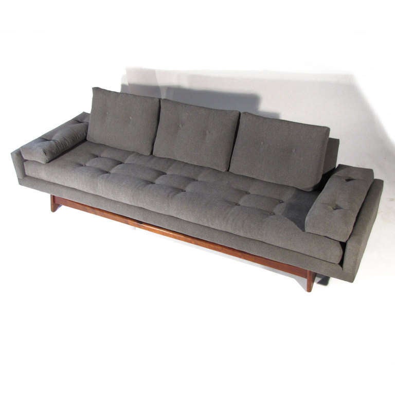 Classic Adrian Pearsall model 2408-S sofa. New symmetrical tufted upholstery in soft slate material. Beautiful rich walnut base. The particular model of Adrian Pearsall is very comfortable with back wedge form cushions and generous depth.
