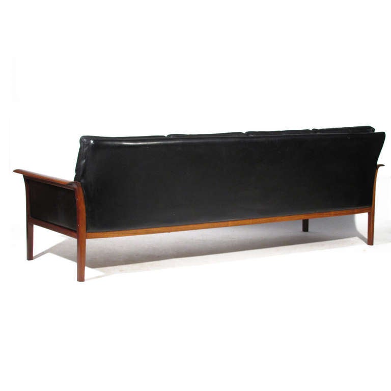 Sleek Hans Olsen for Vatne Mobler rosewood and leather sofa. Deep color and nice figuring. Soft black leather upholstery. Very comfortable with down filled cushions.

Restored condition, both leather and wood. Please call Eddy at 410.299.9147 for