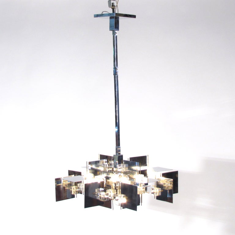Brilliant Gaetano Sciolari chandelier displaying an intricate network of chrome panels, Lucite cubes, and brass rods - all suspended by an adjustable chrome stem. Dazzling both on and off, with reflections and angles galore.