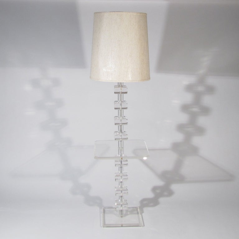 Impressive thick beveled block Lucite floor table lamp with central frosted Lucite shaft, Lucite finial, and chrome hardware. Keep the Lucite lines straight or twist for helix form - or any pattern in between. Beveled table surface and base.

Very