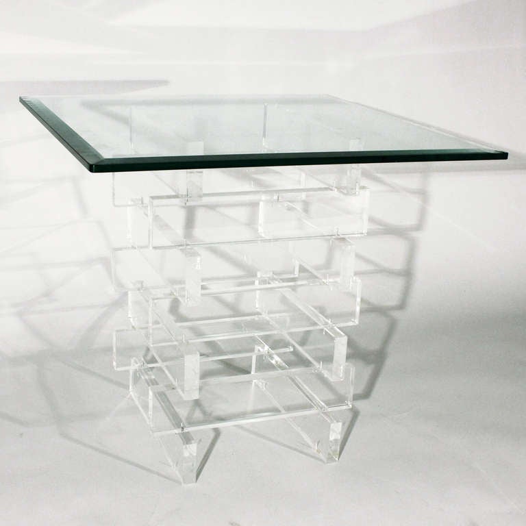 Nice vintage lucite side table. Stacking rectangular lucite blocks or panels form the base supporting a thick beveled glass top. 
In very good vintage condition with only minor wear consistent with age and use.