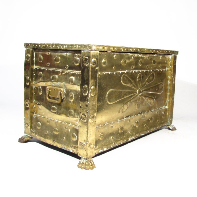 Charming antique brass trunk with lion's feet. Repoussé brass over old wood interior. Movable brass handles

Expected character from age. Overall excellent condition. Please call Eddy at 410.299.9147 for detailed condition report, shipping