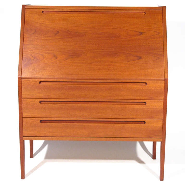 Handsome Nils Jonsson Danish slant top teak desk for Torring Mobelfabrik, produced by HJN Mobler in Denmark. Exceptional craftsmanship with honey birch interior. Note interior two shelves, three drawers with finger joinery, generous work surface,