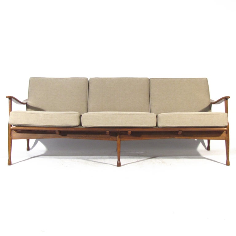 Handsome early 1960's Danish spindle back sofa crafted in solid beech. Newly upholstered in soft oatmeal material with zippered cushions. Very comfortable.