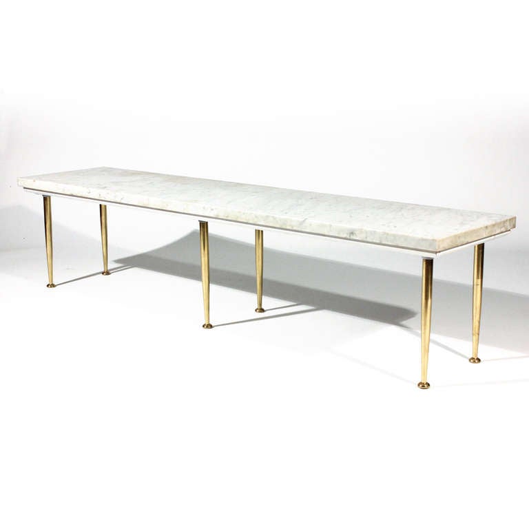 1950's Italian marble top coffee table on 6 tapered brass legs. Simple and elegant.