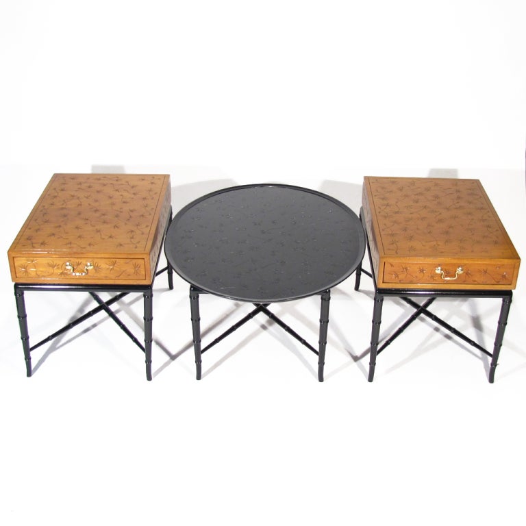 A beautiful trio of Kittinger end tables and oval coffee table featuring fine incised thistle pattern and gently tapered ebonized black faux bamboo bases. The coffee table has been professionally spray finished to match the base. Top portions of end