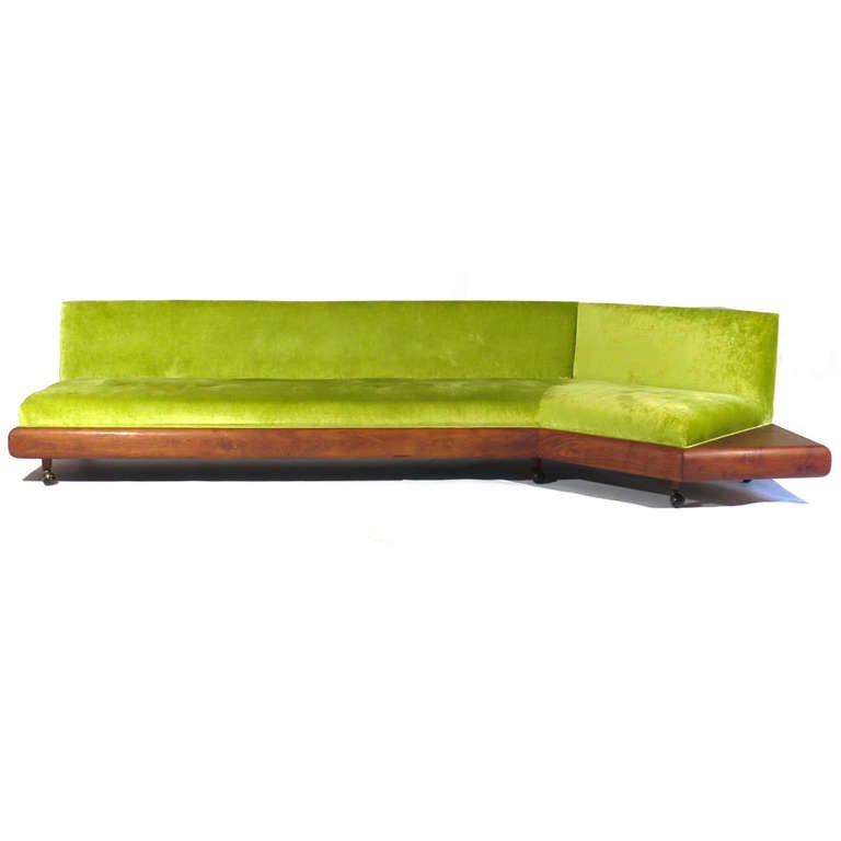 Sleek Adrian Pearsall sofa upholstered in Maharam Kvadrat chartreuse velvet. Corner sofa, with corner table surface behind right quarter. Beautiful walnut skirt and table surfaces.

Newly upholstered. Restored walnut frame.