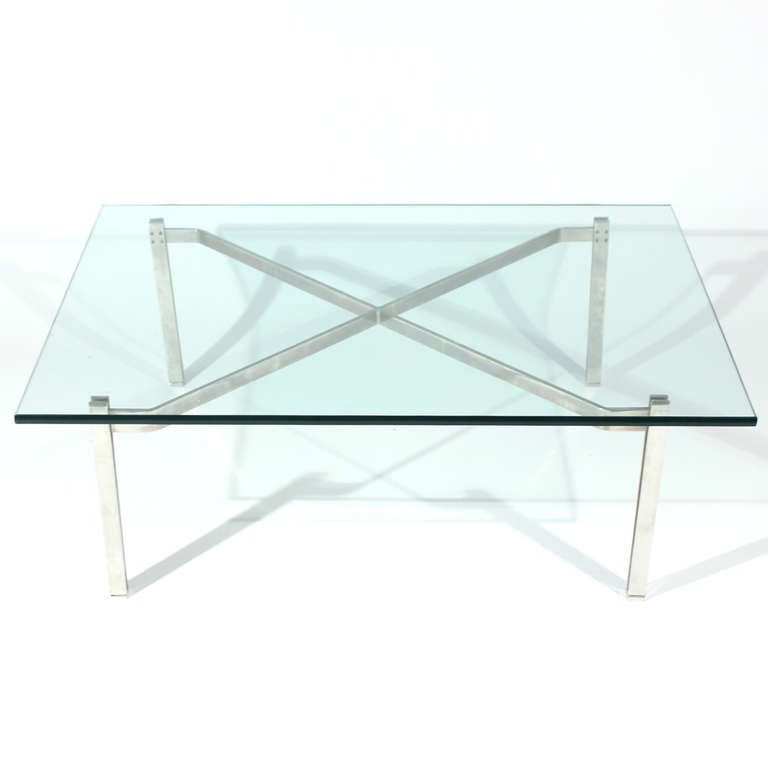 This table is often attributed to Poul Kjaerholm and no wonder... We've had several of Kjaerholm's PK61 tables over the years and this table has a familiar aesthetic with 1 inch thick square glass over steel flat-bars making up the base in this case