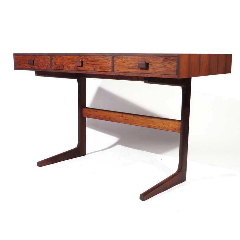 Georg Petersens Mobelfabrik model 3520 Farum Danish writing table in rosewood with dramatic figuring and beautiful colors. Sleek cantilever open design with three deep drawers. Farum label affixed to underside.

Immaculate restored condition.