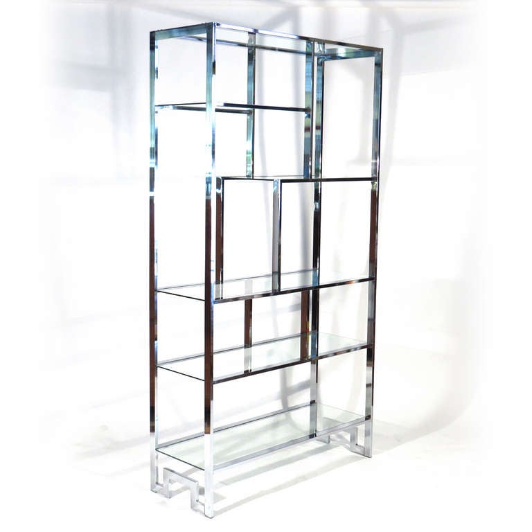 Milo Baughman Mondrian form etagere in chrome with a multitude of shelving.

Immaculate condition. New glass or mirror for shelves to be cut just before shipping.