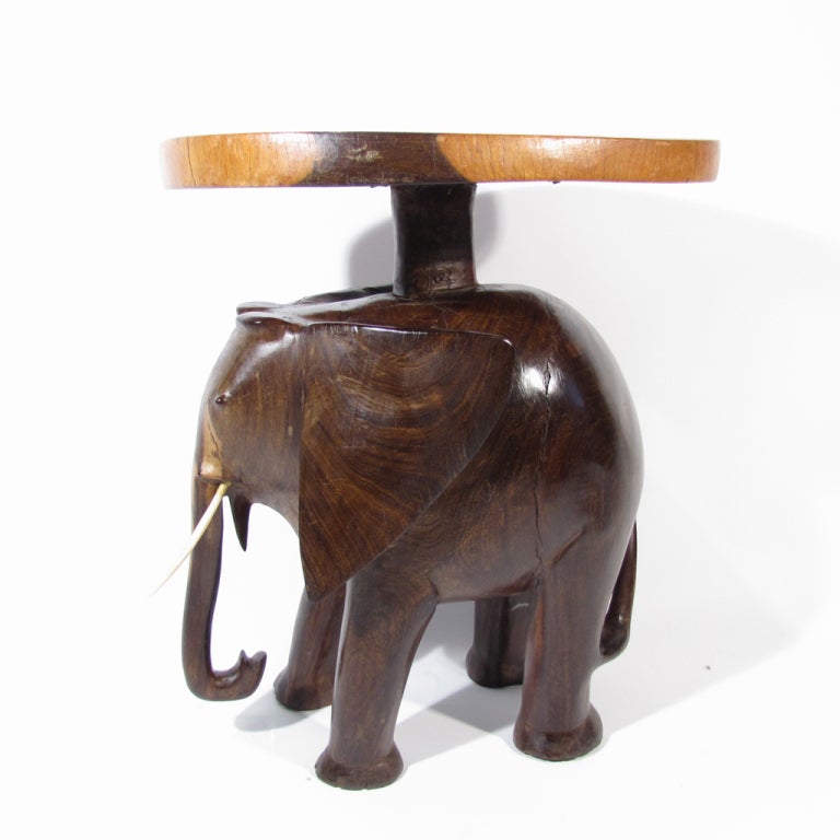 Beautiful elephant occasional table hand carved in solid rosewood. Exceedingly heavy in both weight and character. Honey to deep espresso colors with attractive rosewood figuring.

Original finish and natural character. Please call Eddy at