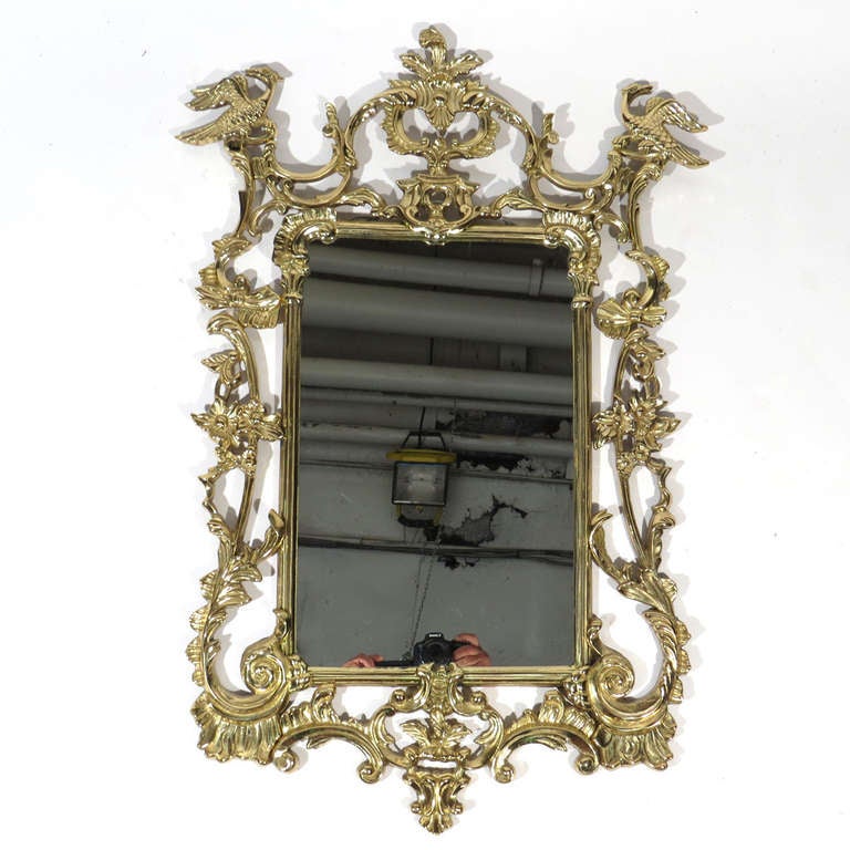 Ornate Maitland Smith solid brass mirror with scrolls and details galore, along with perched griffins in upper corners. Quite heavy and beautiful. Maitland Smith label affixed to back.

Pristine condition.