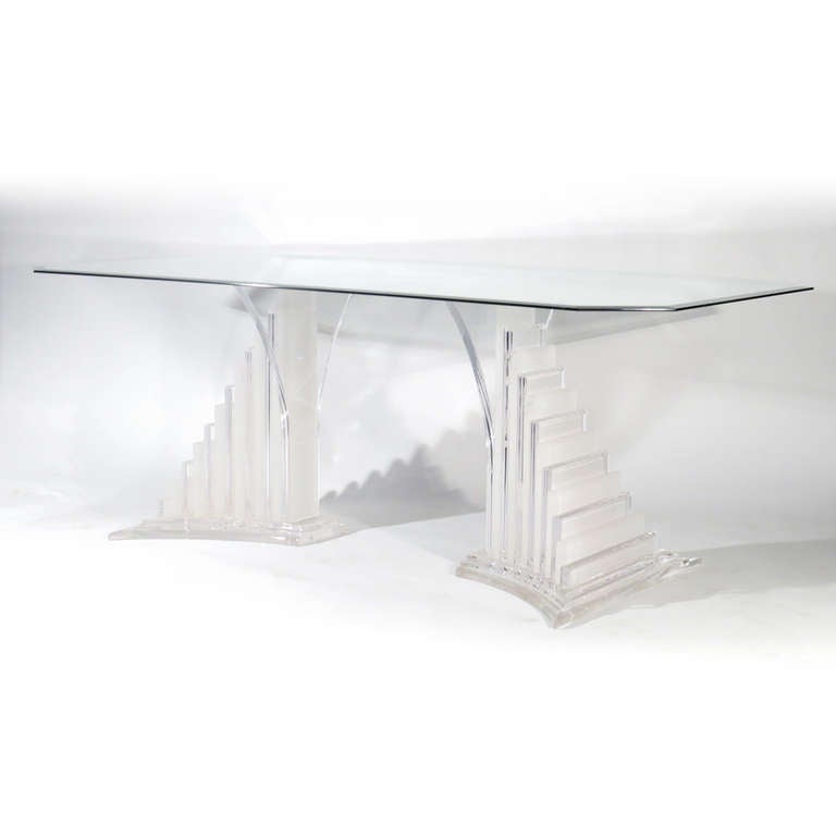 Lucite dining table consisting of matching alternating clear and frosted Lucite halves with triangular stairway form. Base would also support console or hall table glass. Bases could be pushed closer or further apart. New glass will be cut to