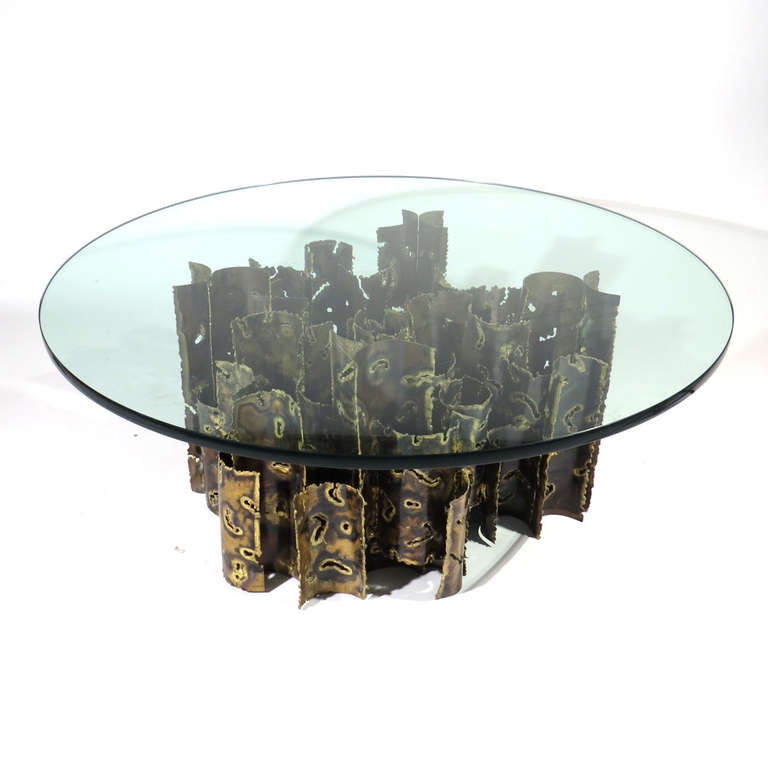 Dramatic torch cut brutalist coffee table. Entangled semi-circular rods joined together support glass top. Heavy and very well crafted.

New glass.