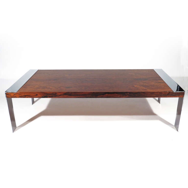 Striking Milo Baughman coffee table. Exceptionally wide flat bar chrome frames with dramatic rosewood figuring on top and sides.

Refinished rosewood. Excellent chrome.