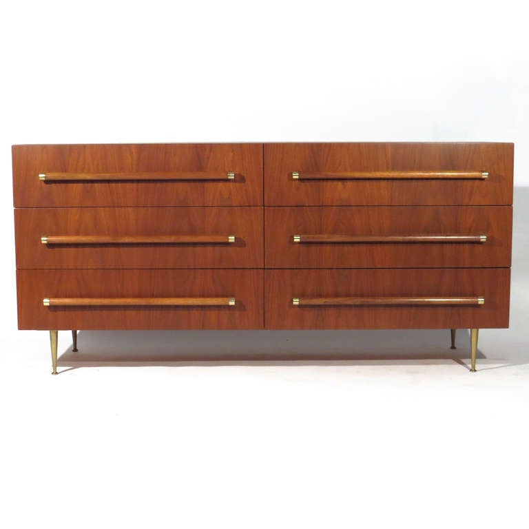 T.H. Robsjohn-Gibbings for Widdicomb six drawer dresser in walnut. Satin brass legs, beautiful figuring. Gibbings | Widdicomb label affixed in drawer.