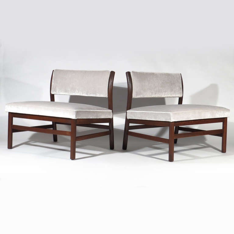 Sleek pair Harvey Probber slipper chairs upholstered in Romo Zinc Orbit Dove velvet. Deep walnut frames.