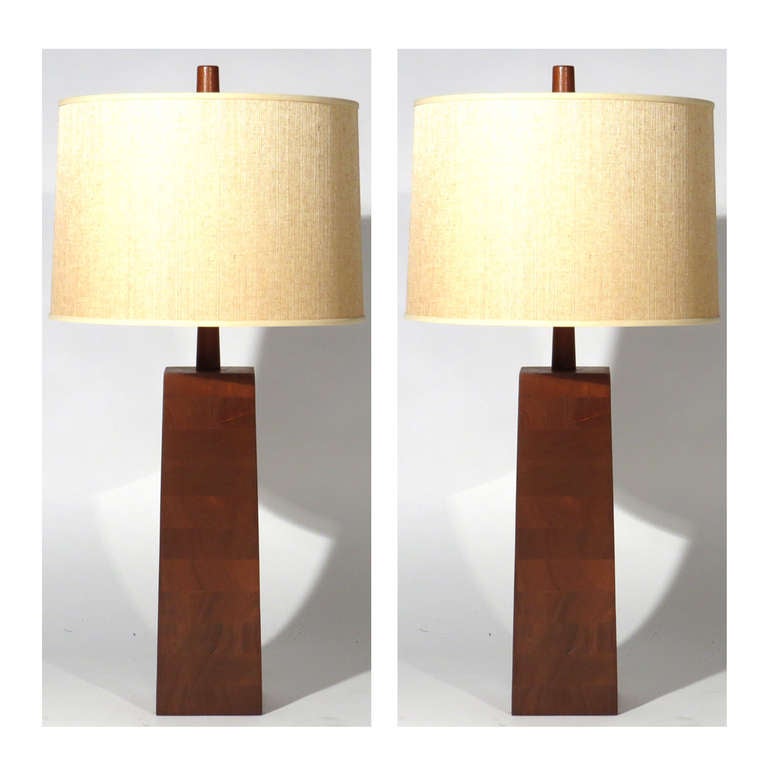 Handsome pair Mid-Century solid walnut lamps. Quite heavy, wired for three way bulbs. Brass hardware, walnut stems and finials. Height shown is to bottom of socket.

Restored walnut.