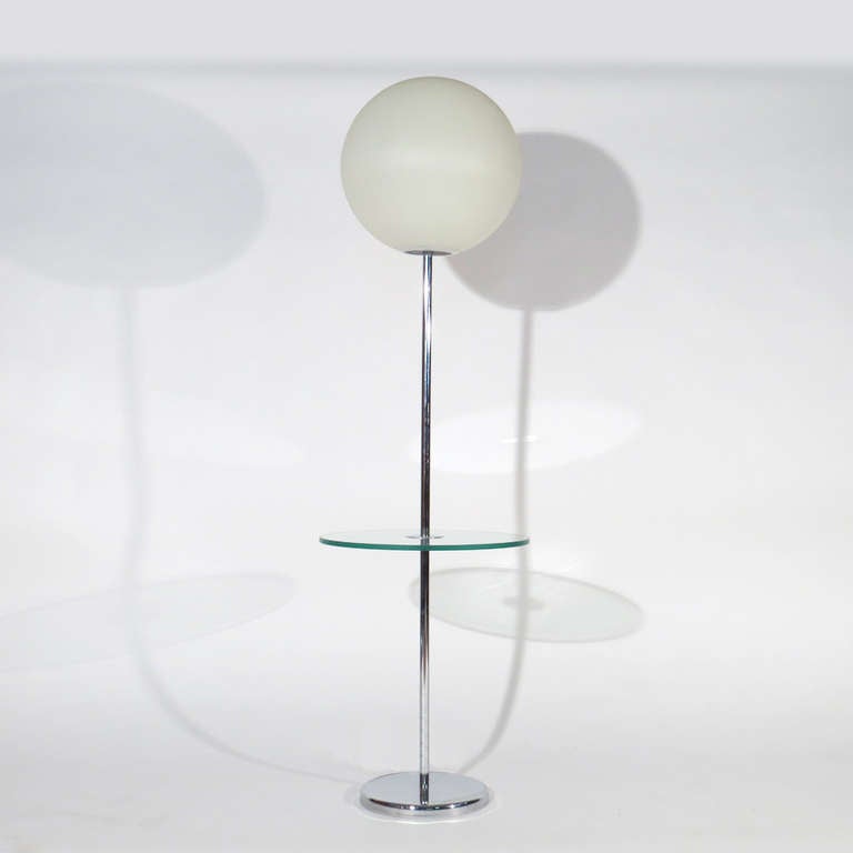 Robert Sonneman table lamp. Chrome base and stem with glass shelf. Heavy resin globe. Original tags included with the terrific Robert Sonneman slogan 