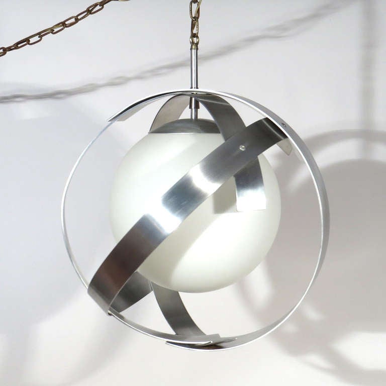 Spectacular mod pendant fixture. Large case glass globe surrounded by aluminum swirls. Very unusual form.