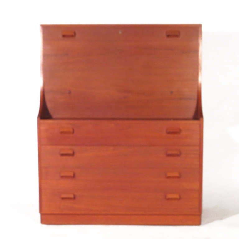 Handsome Borge Mogensen secretary desk. Three lower drawers below generous writing surface, below various drawers and compartments. Brass hardware. Beautiful deep teak color. 28.5 inch writing surface. Pristine restored condition.