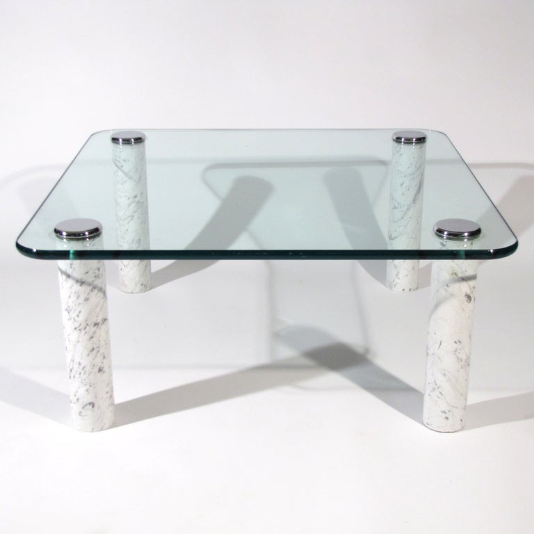 Pace Collection cocktail table with solid Carrara marble legs  topped with chrome caps. Three quarter inch glass with soft corners. 

Original thick glass free off chips and scratches. Overall excellent condition.