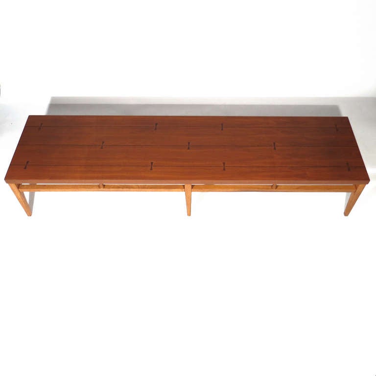 Handsome Mid-Century coffee table in walnut with rosewood bow tie and ebony pinstripe inlay. Superb restored condition.