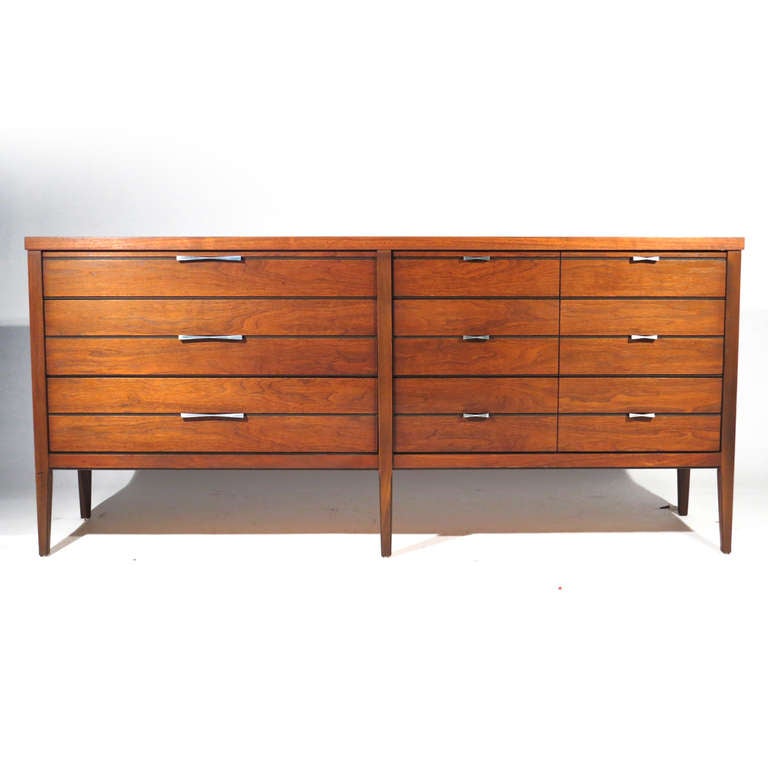 Handsome Mid-Century nine drawer dresser in walnut with rosewood bow tie and ebony pinstripe inlay. Matching cast aluminum pulls. Superb restored condition.