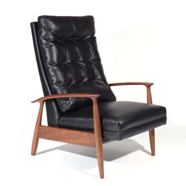 Milo Baughman for Thayer Coggin recliner. Tufted black leather upholstery with sculptural walnut frame. Adjusts to multiple positions.  Exceedingly comfortable.