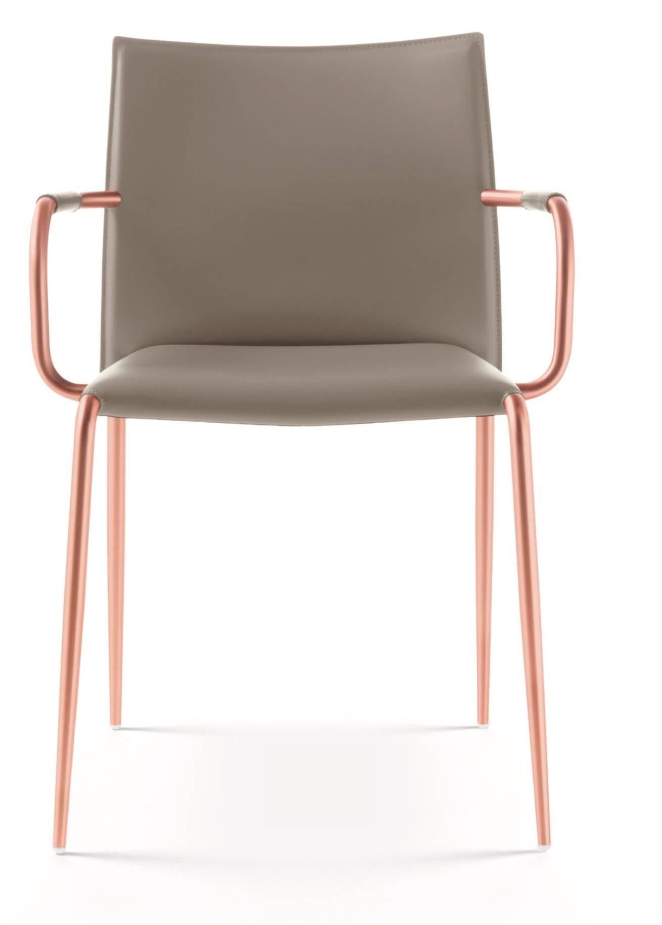 Italian modern dining room armchairs with tubular iron frame and hide leather seat and back. Tabular iron frame of a diameter of 22 millimeters tapered available in chrome, satin nickel, copper plating finished bronze, graphite. This Italian arm