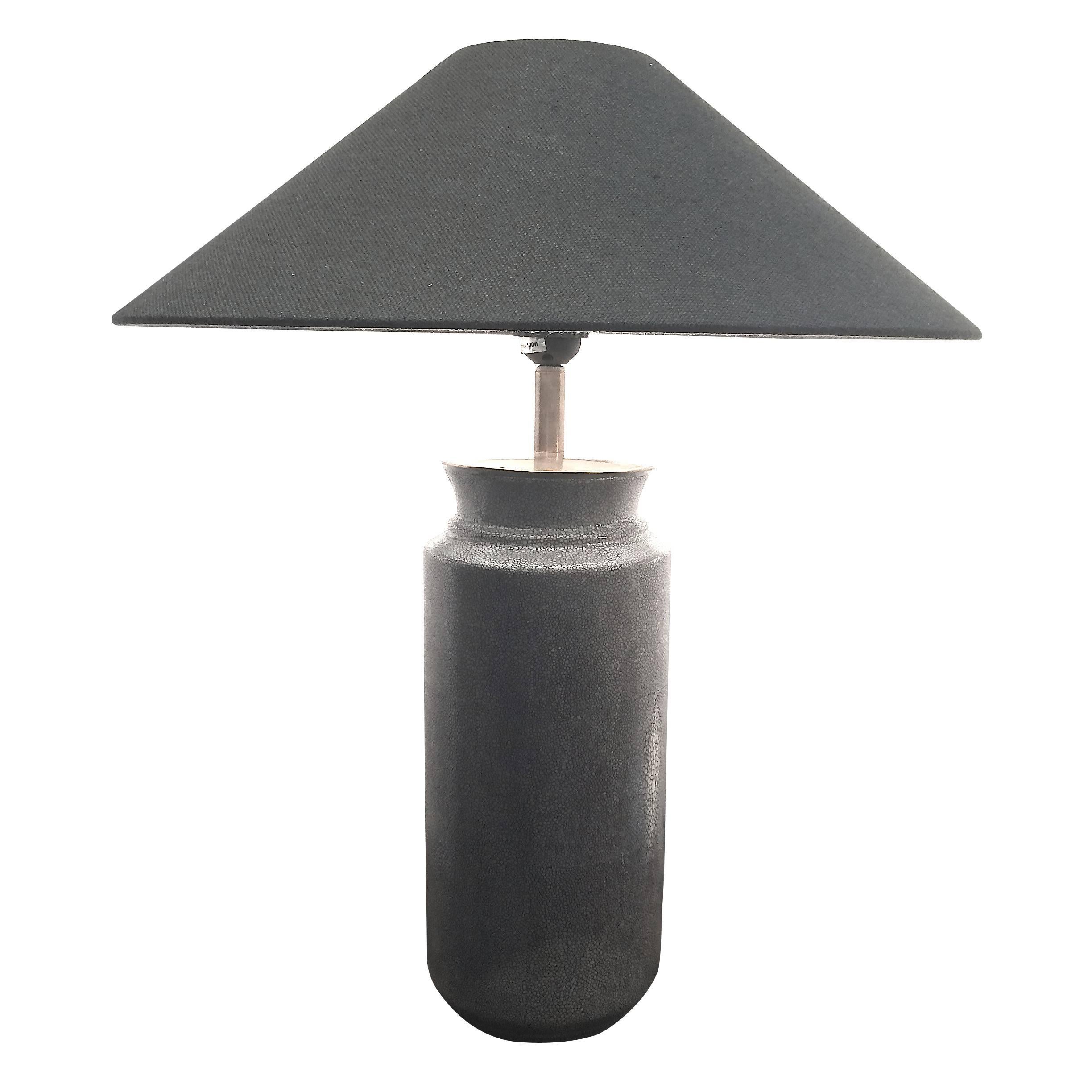 Grey faux shagreen contemporary Chinese pair of cylinder shaped table lamps.
The faux shagreen pattern is etched onto a porcelain base.
Measure: The shade is fine black Belgian linen with white interior and is 20