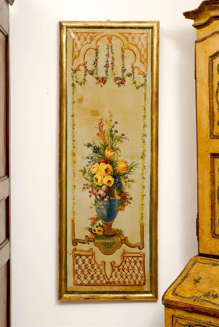 A pair of French Napoleon III period painted decorative panels with floral motifs from the mid-19th century, set inside giltwood frames. Each of this pair of decorative panels features an exquisite décor made of colorful bouquets displayed in green