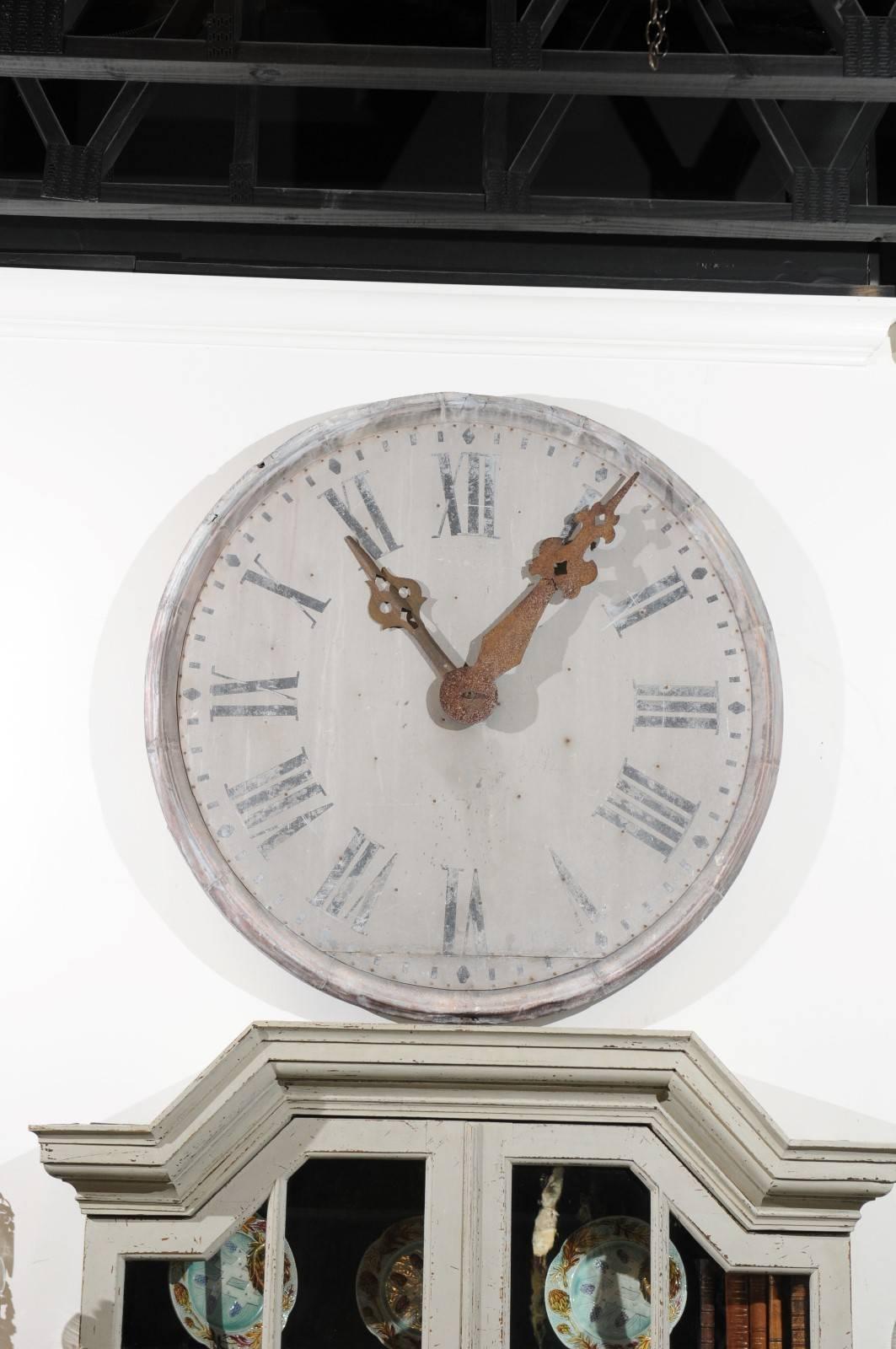 A French large size zinc decorative clock face with Roman numerals and original hands from the late 19th century. Set within a simple circular frame, this French clock features a nicely weathered face with Roman numerals and exquisite rusty iron