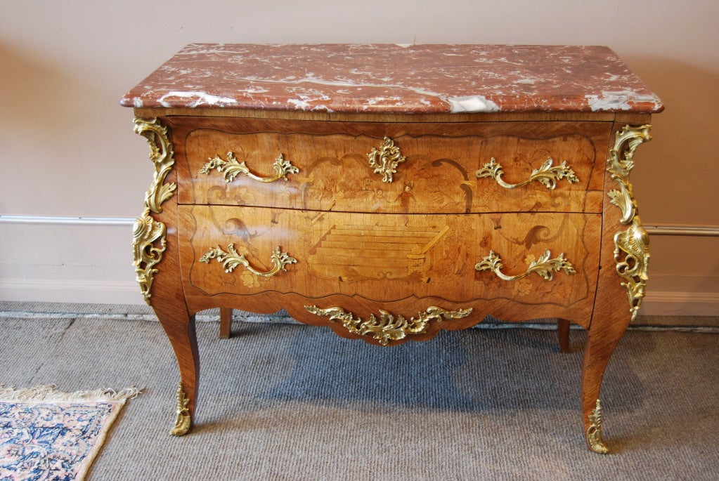 Rare marquetry inlaid Kingwood and Rosewood Louis XV style commode gilt metal mounted and stamped under the marble top. From the family of a former Canadian Ambassador to Argentina.