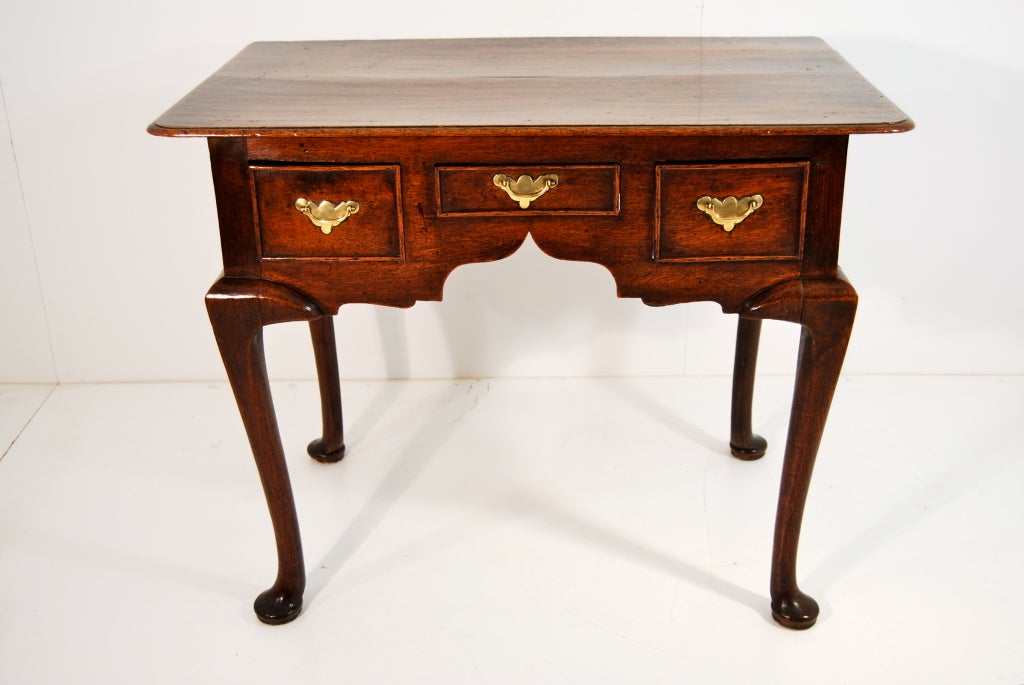 Lovely oak lowboy with 3 drawers and four cabriole legs on pad feet.  Probably American.