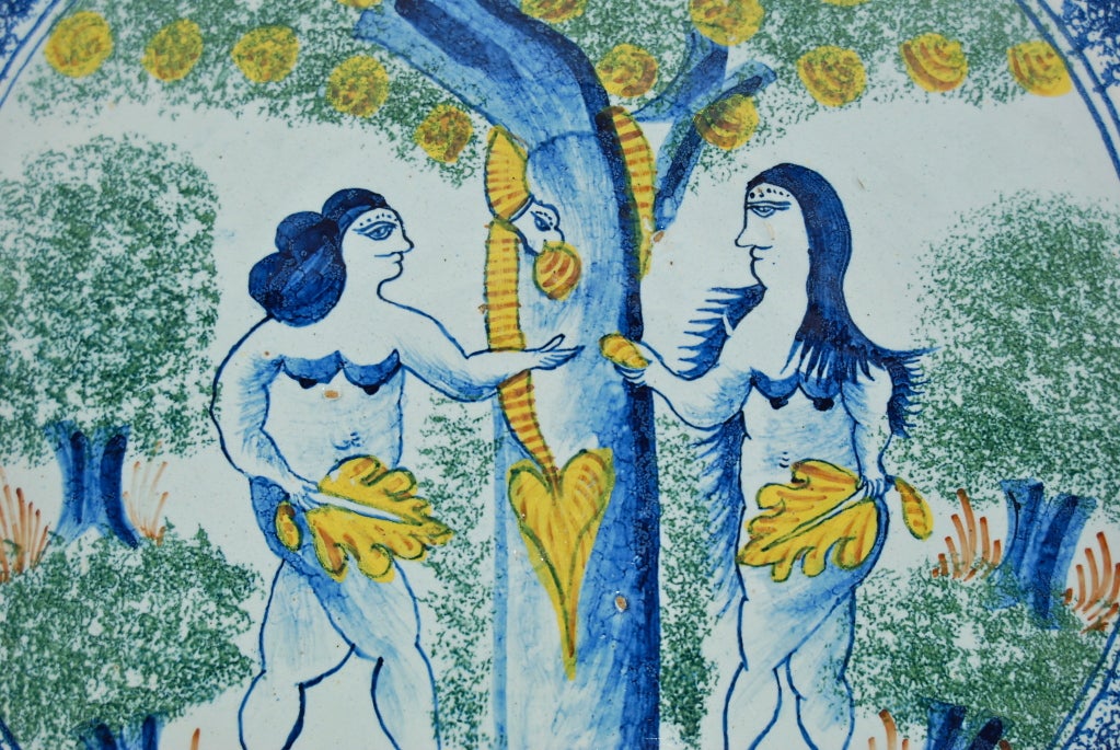 Painted in green, blue and ochre with Adam and Eve flanking an apple tree, she passing him an apple and the serpent entwined about the trunk, flanked by two-tiered trees with sponged green foliage, within a blue line rim sponged in blue.

From the