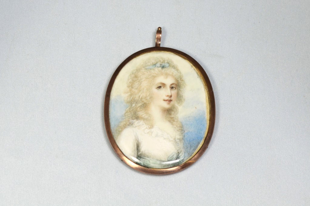This unknown lady is painted on ivory in the style of Richard Cosway (1742-1821) with a blue and cloudy sky background. Like many miniatures and pieces of jewellery from the eighteenth century that included hairwork, this portrait miniature features