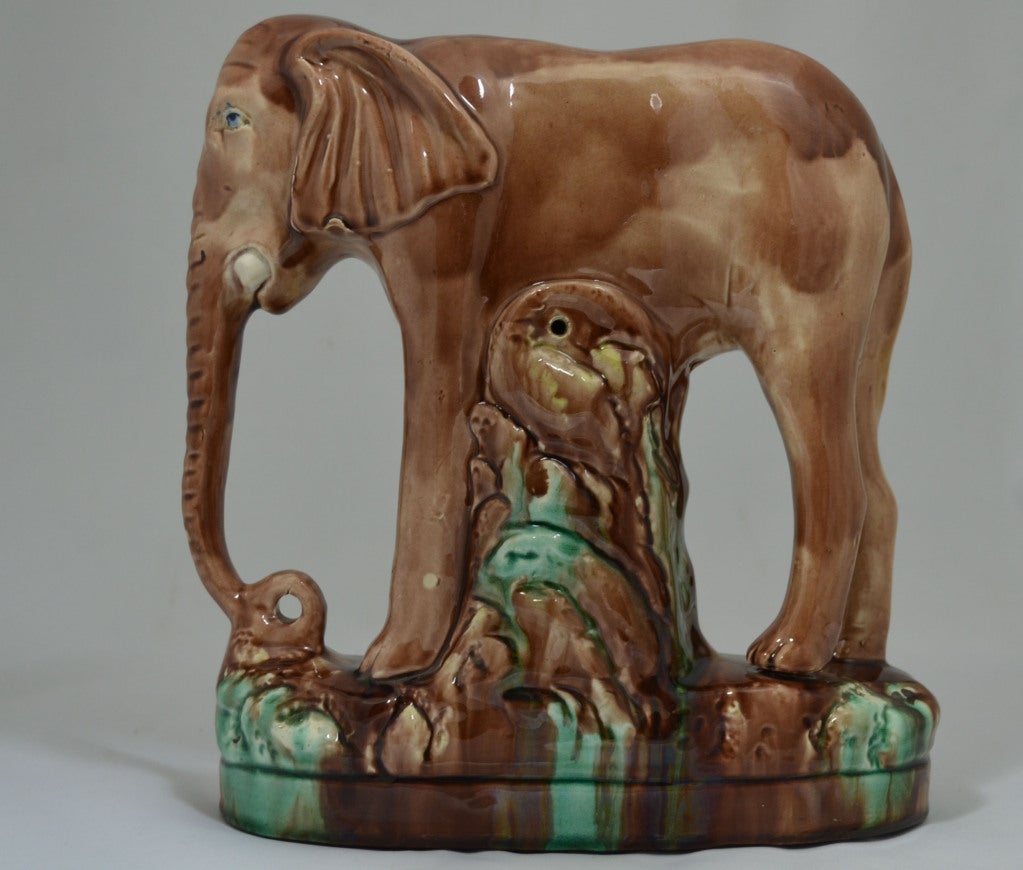 Victorian earthenware pottery figure of an elephant. Decorated in browns with blue eyes and the base is a combination of browns, creams, and pale green. Jumbo was an approximately twelve feet tall elephant, born in the French Sudan in the early