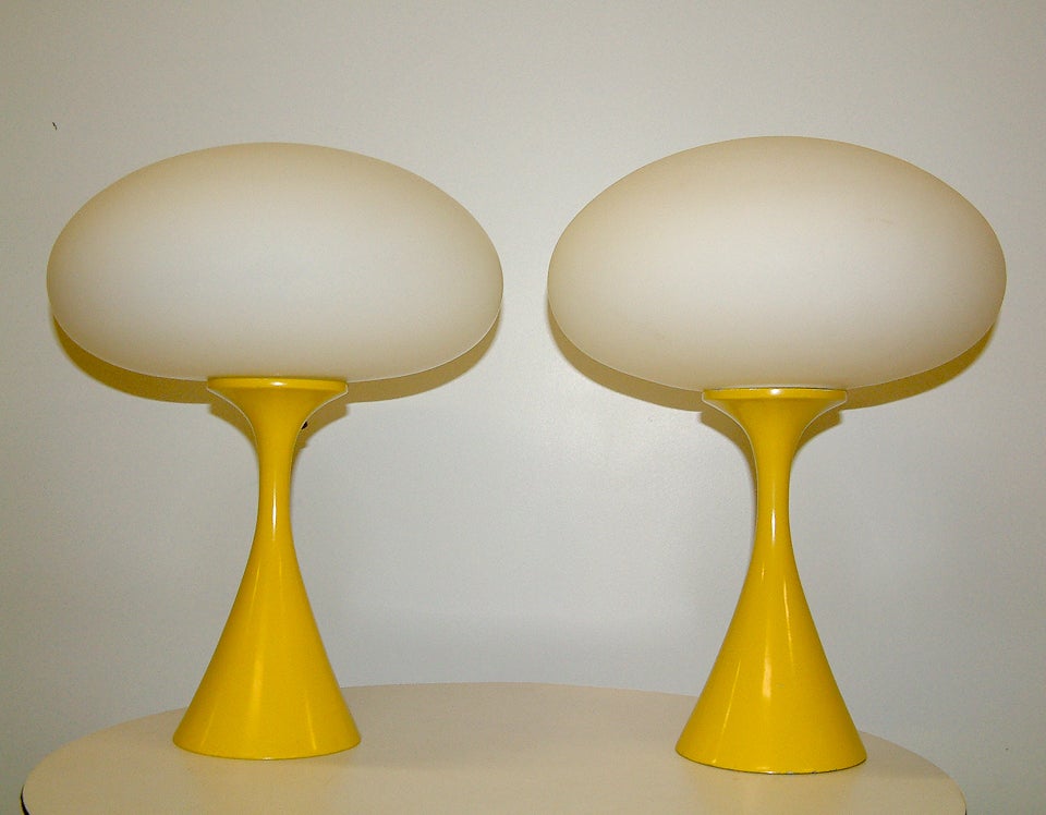 A pair of enameled steel and frosted glass lamps in original yellow paint finish. Signed with manufacturer's label decal to the metal diffuser and comes complete with the original manufacturer's hang tag.